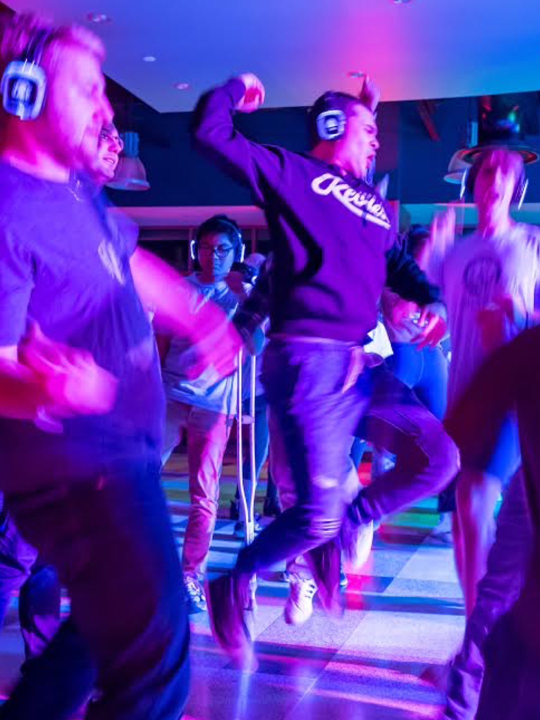 Villanova students dancing at a colorful silent disco.