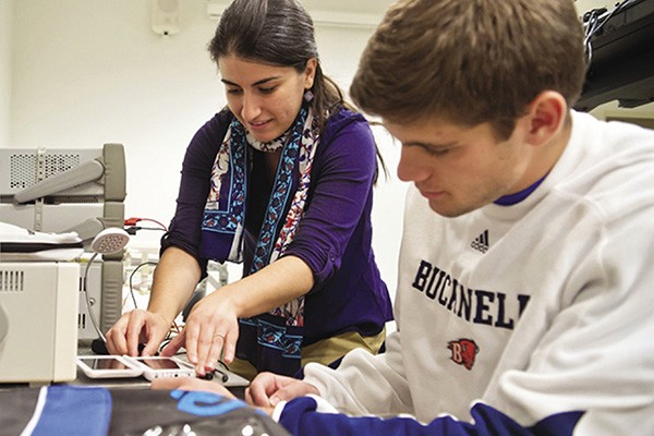 Amal Kabalan, assistant professor at Bucknell University, works with a student in the lab.