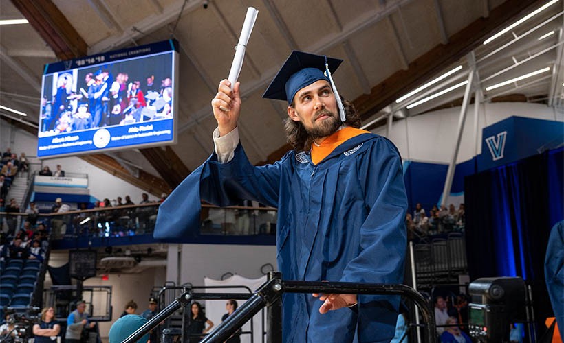 Engineering Graduate Studies A male graduate holding a diploma