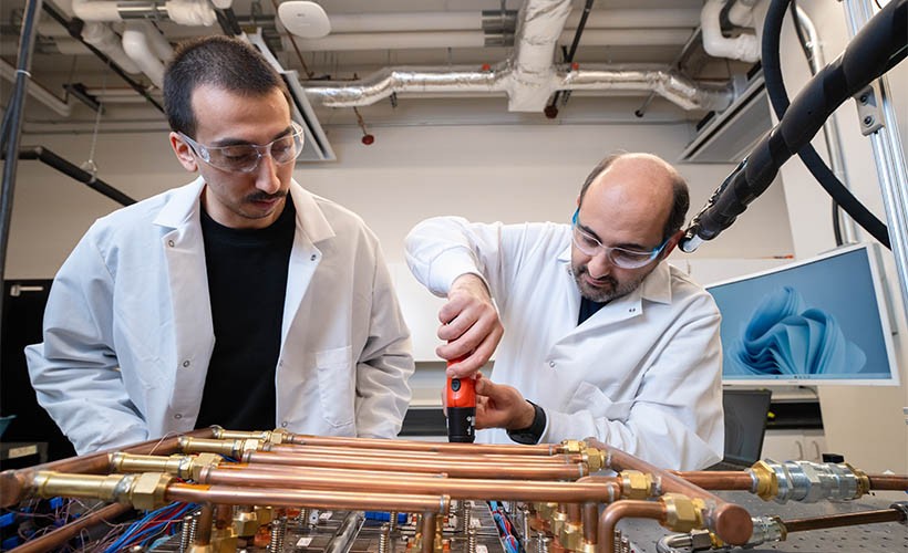 Proposing Solutions to Data Center Inefficiency Two grad students working in the ES2 lab