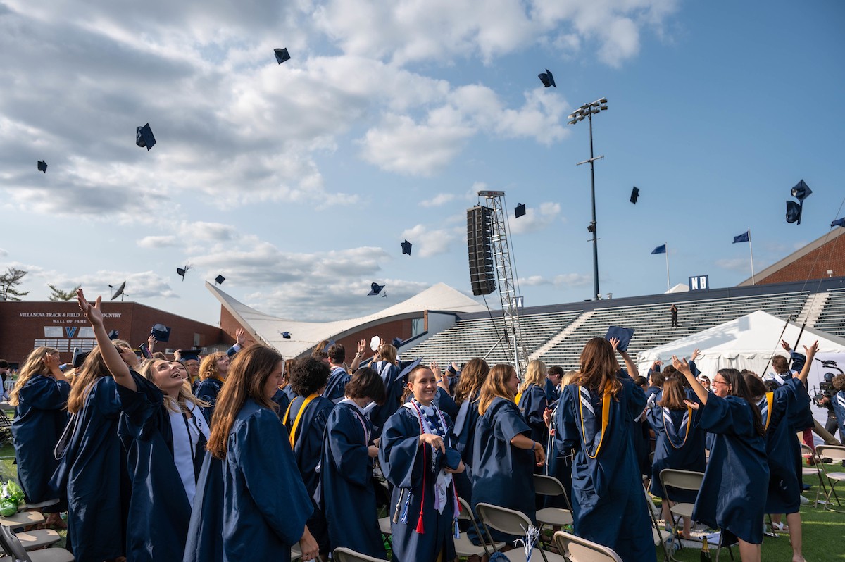 Students throwing up their graduation caps at a graduation ceremony