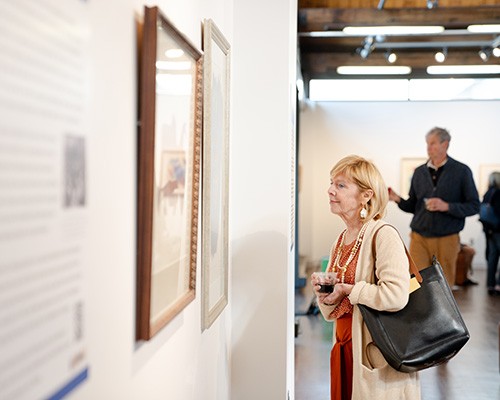 Patrons look at a piece at the exhibit, "Abstract Activism: Sam Maitin's Philadelphia." Patrons look at a piece at the exhibit, "Abstract Activism: Sam Maitin's Philadelphia."