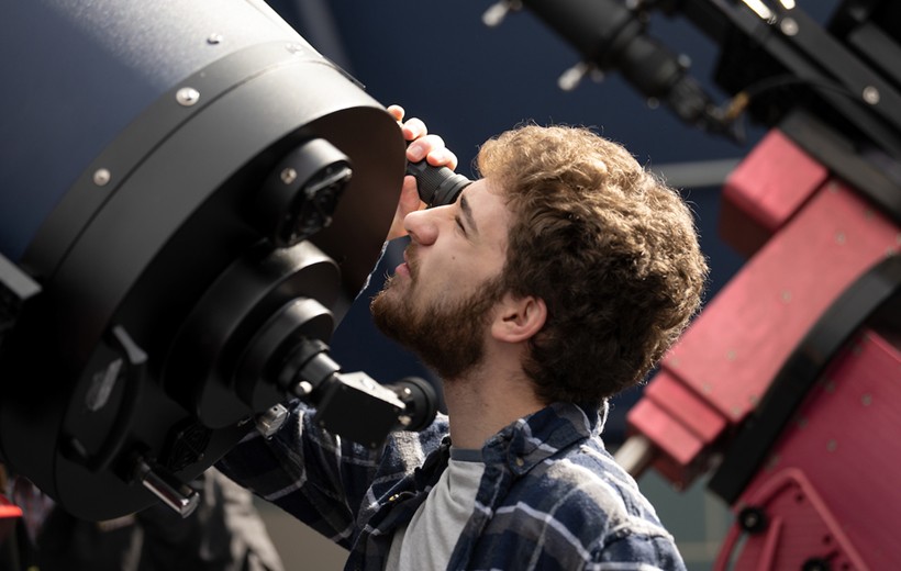 A student works with the rooftop telescope. A student works with the rooftop telescope.