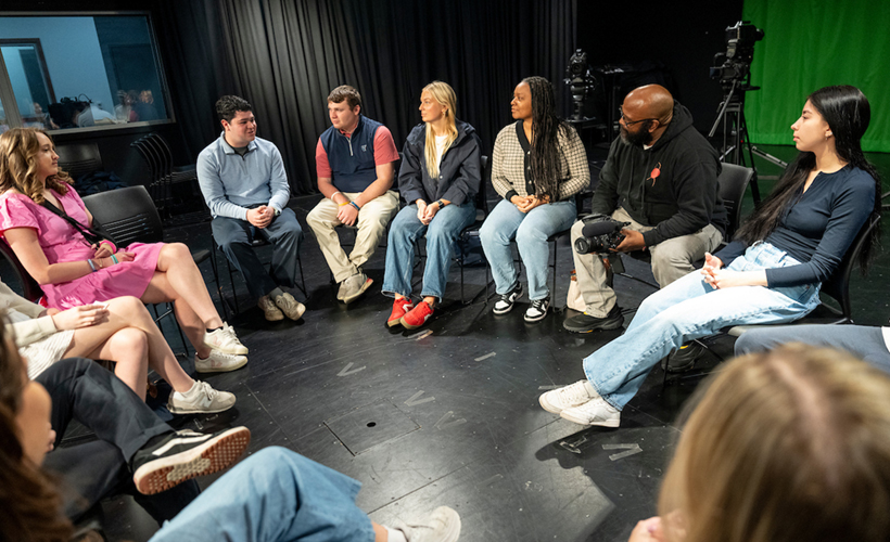A group of students in class in the Communication studio.