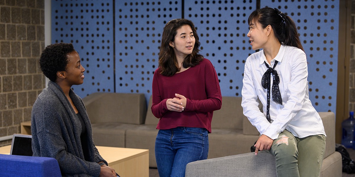 Graduate students talking in preparation for class image of students talking