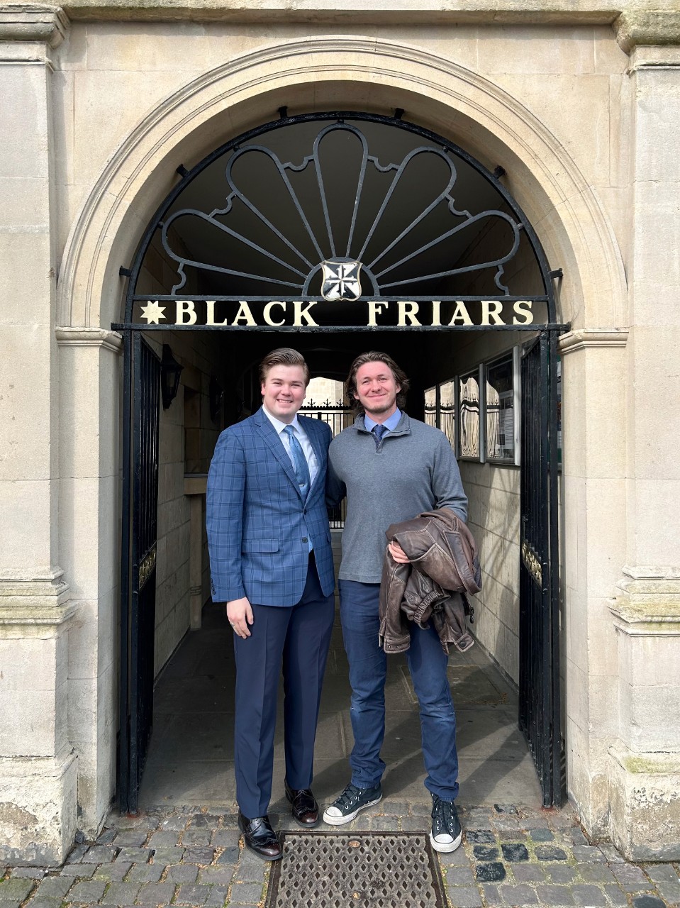 Student stands outside a Blackfriars sign in Oxford. Student stands outside a Blackfriars sign in Oxford.