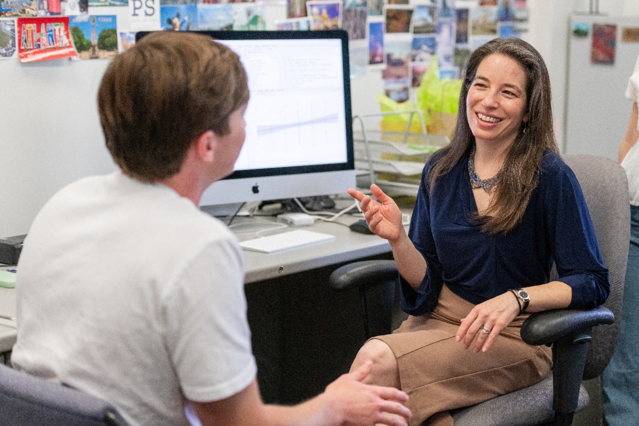 Dr. Weisberg, seated, speaks with a student Dr. Weisberg, seated, speaks with a student