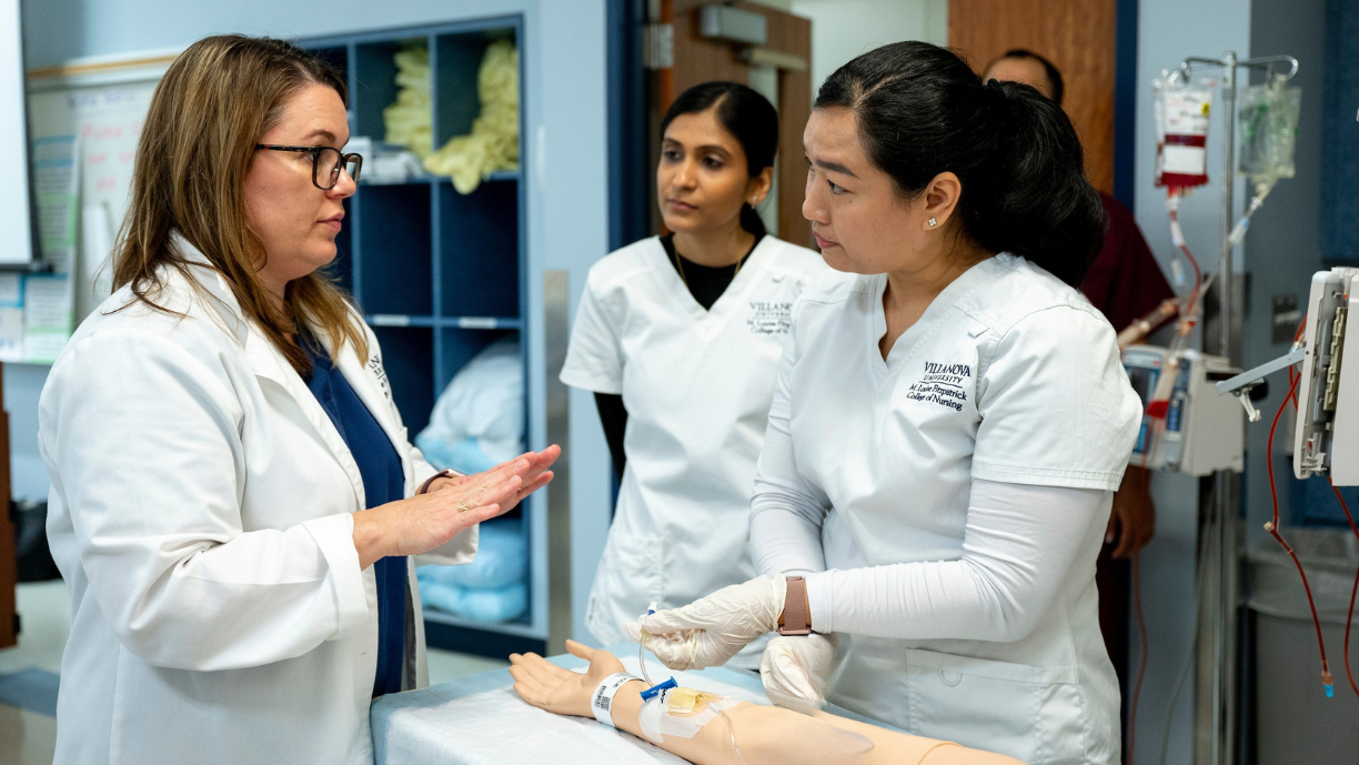 Website Header Image - SLRC Header Image 2 Nursing faculty teaching students how to work an IV