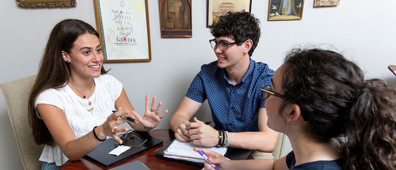 Students in discussion sitting at table