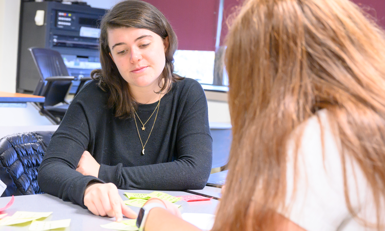 Students sitting at desk with notes