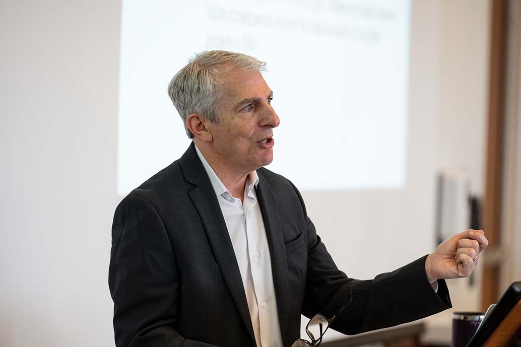 A male Graduate Tax faculty member lecturing students in classroom