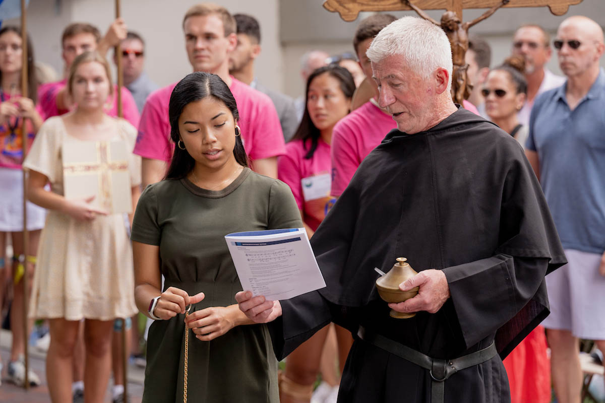 Male student playing cello at mass