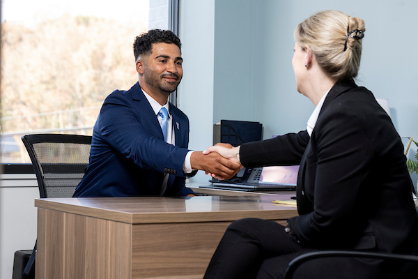 two people shaking hands in an office