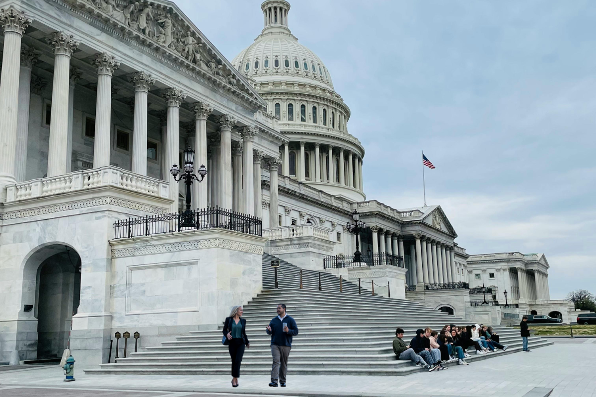 photo of Capitol Hill with people in foreground