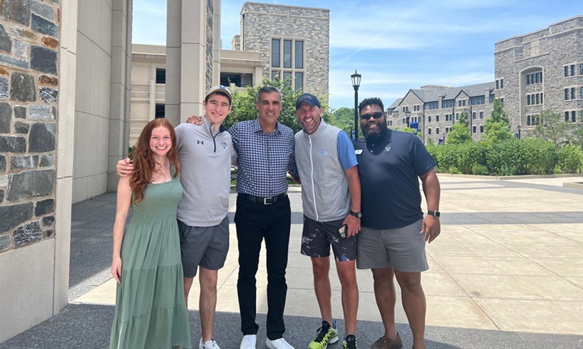 Group image of LEVEL members with Coach Jay Wright