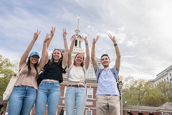 Students holding their Vs up in front of Independence Mall