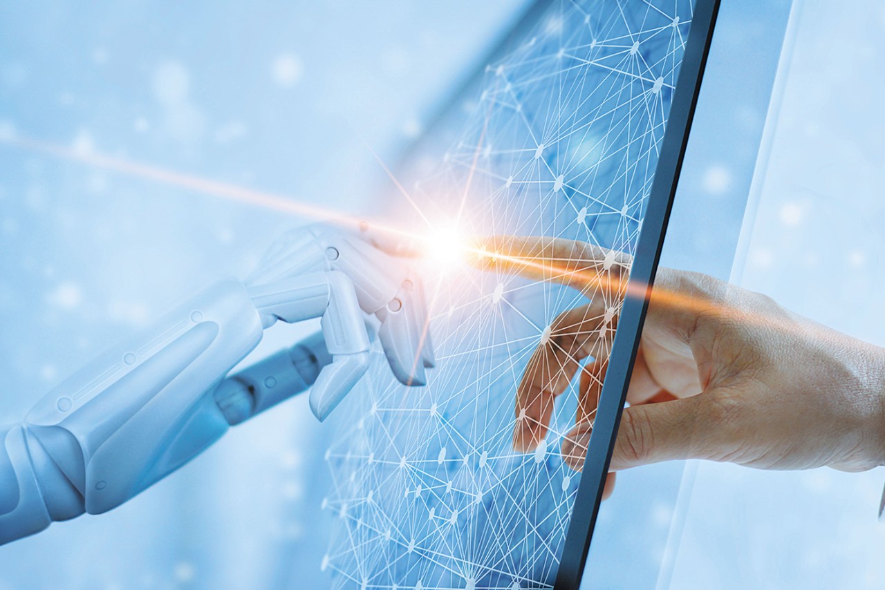 the hands of a robot and human touching fingers